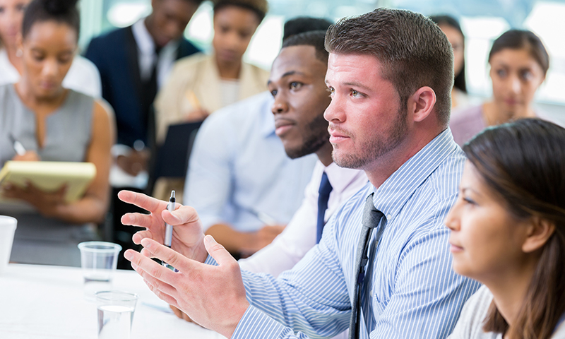 image: people in review board meeting.